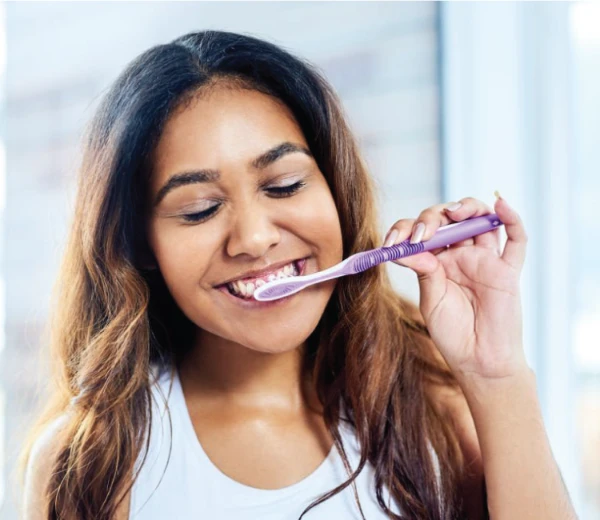 woman brushing her teeth