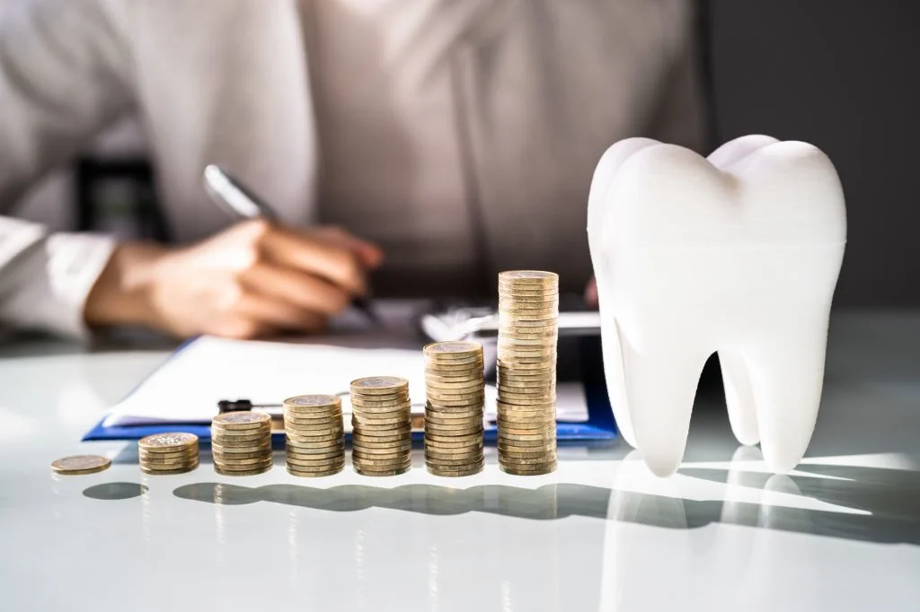 Big tooth prop with some coins on the table