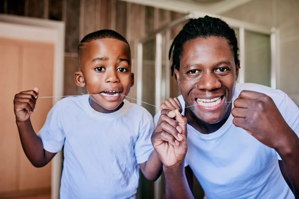 Father and son flossing