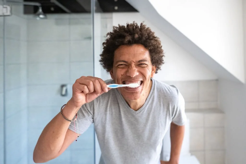 Old man brushing his teeth