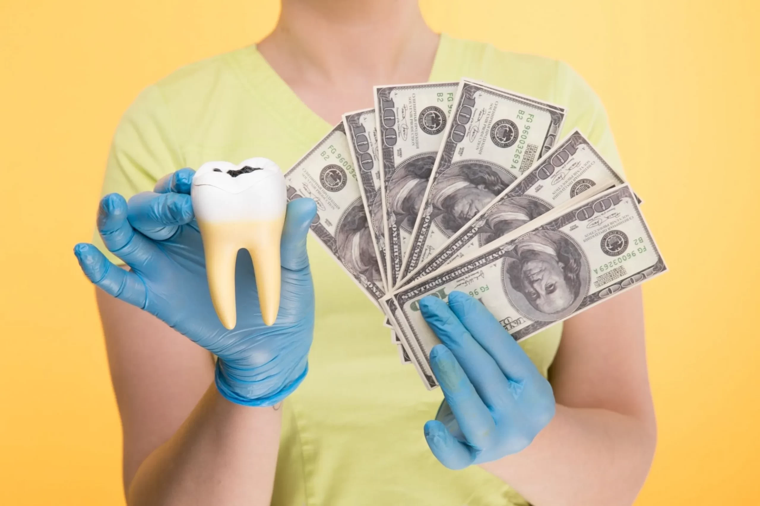 Doctor holding teeth prop and money